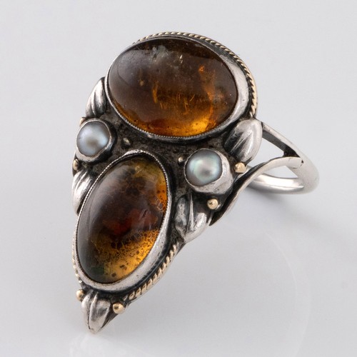 118 - An early 20thC Arts and Crafts citrine and pearl ring, decorated with two large oval citrine cabocho... 
