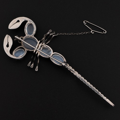 173 - A 1930s English Art Deco silver scorpion moonstone brooch, decorated with graduated high quality moo... 