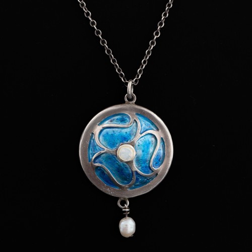 85 - An Arts and Crafts enamel pendant, c.1905, decorated with blue enamel set within a contoured wirewor... 