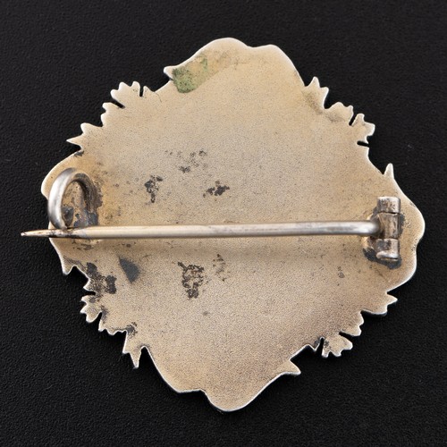 92 - An early 20th century Continental white metal and enamel portrait brooch, with portrait of a young l... 