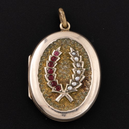 93 - An early 20th century silver gilt locket, unmarked, the cover decorated with a spray of seed pearls ... 