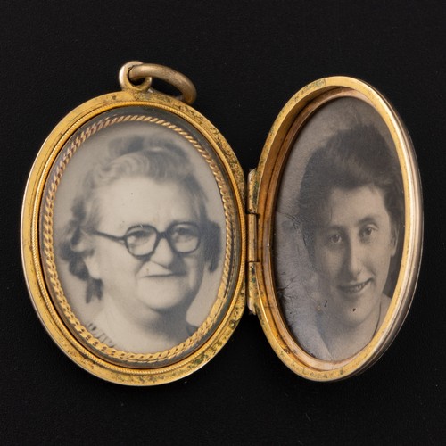 93 - An early 20th century silver gilt locket, unmarked, the cover decorated with a spray of seed pearls ... 