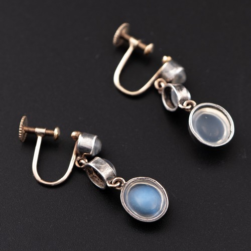 176 - A mid-20thC style pair of yellow and white metal earrings with moonstones, the back with screw threa... 