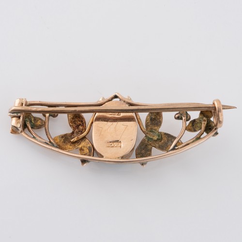 129 - A Liberty of London 9ct gold and turquoise brooch, with openwork frame depicting leaves and berries ... 