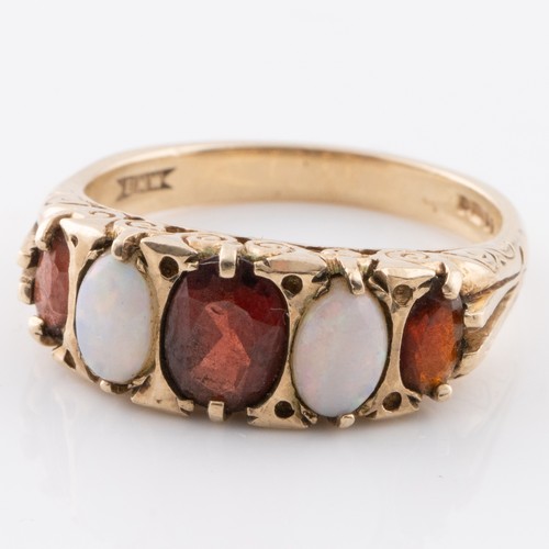 178 - A 9ct gold ring made in London 1973, with opals and garnets, ring size Q. (LC340)