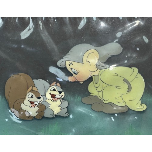 An original Walt Disney 'Snow White and the Seven Dwarfs' (1937) screen used production/animation cell, depicts 'Dopey' and his woodland friends, with autographed card signed with fountain pen ink 'WALT DISNEY', framed and glazed, 25cm height, 29.5cm width.