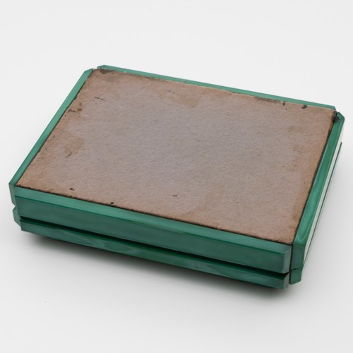 A Czech malachite glass cigarette box, c1935, malachite glass depicts a man  wearing a sombrero playi