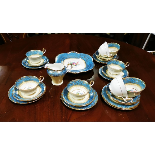 281 - 8 place setting Aynsley Teaset, blue and gold borders with floral patterns (signed at base 7840) in... 