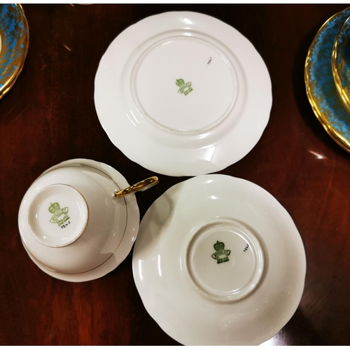 281 - 8 place setting Aynsley Teaset, blue and gold borders with floral patterns (signed at base 7840) in... 