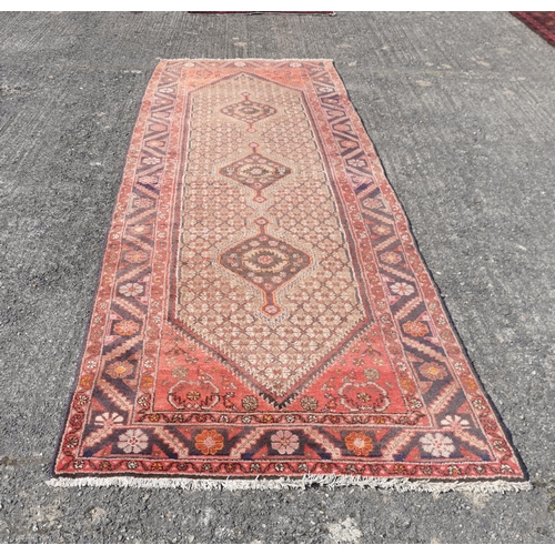 384 - Terracotta ground Persian Hamaden Runner, treble medallion design, 3.1m x 1.15m