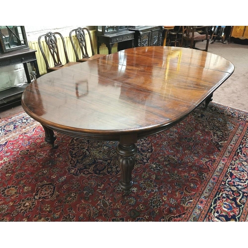 115 - A fine Victorian Mahogany Dining Room / Boardroom Table, with oval shaped ends, on turned and reeded... 