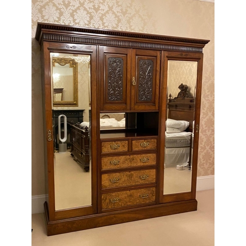 133 - Large Walnut Compactum Wardrobe with two mirrored doors enclosing hanging robes, 5 central drawers a... 