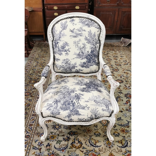 16 - Good Blue Toile Covered Armchair, studded borders, with a curved back, cream-painted frame, on cabri... 