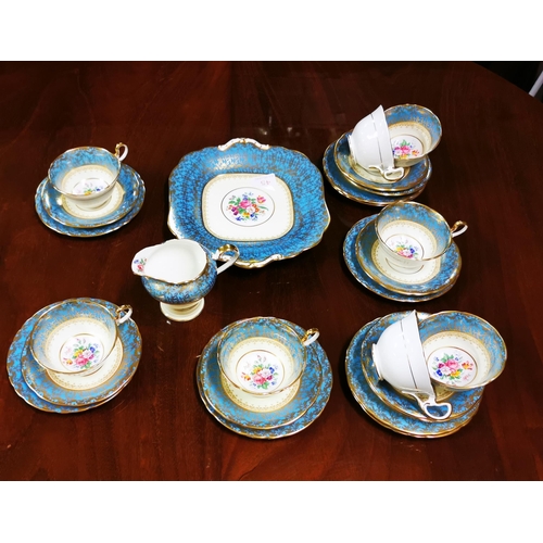 281 - 8 place setting Aynsley Teaset, blue and gold borders with floral patterns (signed at base 7840) in... 