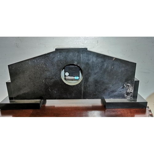 487 - Art Deco Red Faced Marble Clock, with silvered numerals, the black marble stand decorated with feedi... 