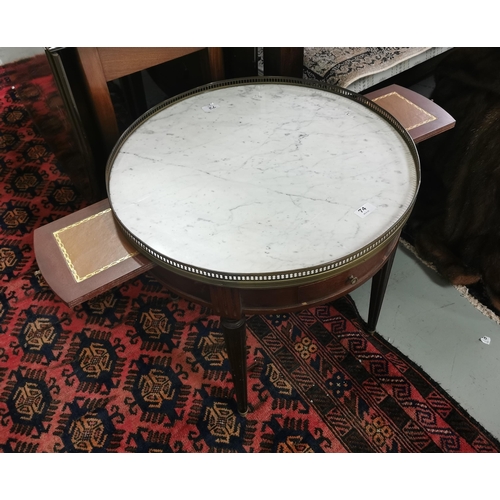 74 - Low sized circular drinks table, with a white marble top, brass gallery and sliding trays, 4 reeded ... 