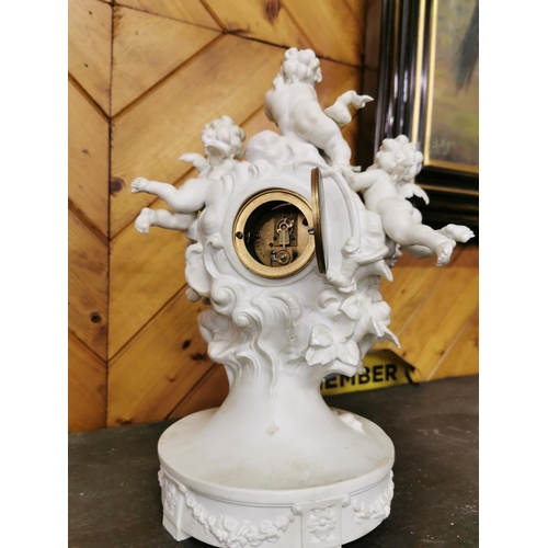 484 - Porcelain Cased Mantel Clock, featuring 5 applied heavenly cherubs (some damage to cherubs), with a ... 