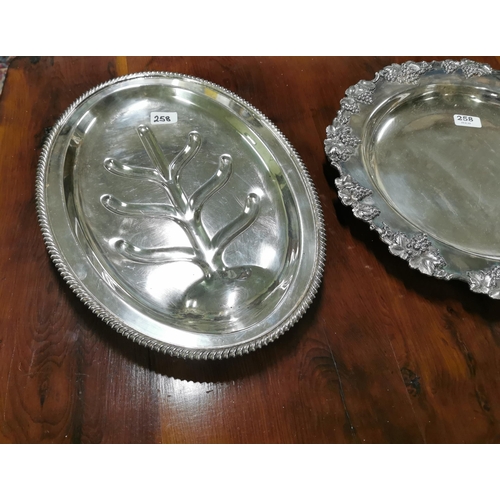 258 - Silver plate on copper good oval meat dish with well and 2 ornate rimmed circular presentation plate... 