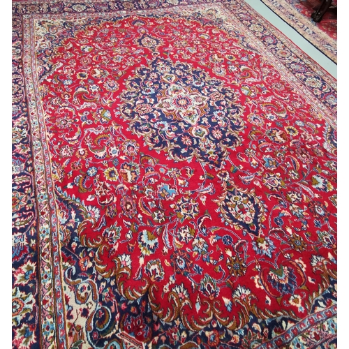 371 - Persian red ground full pile Mashad Carpet, floral medallion design, with vases designs, 4m x 3m