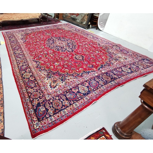 371 - Persian red ground full pile Mashad Carpet, floral medallion design, with vases designs, 4m x 3m