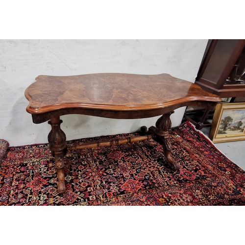 113 - Victorian Walnut Centre Table, the serpentine shaped top over a turned stretcher and four cabriole l... 