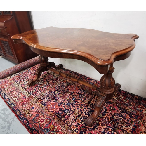 113 - Victorian Walnut Centre Table, the serpentine shaped top over a turned stretcher and four cabriole l... 