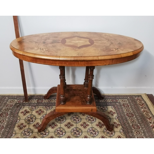 119 - Oval topped Walnut Centre Table, shell inlay to the top, 4 pillars below, on 4 splayed feet  70cmH ... 