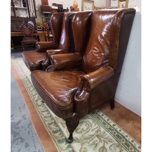 15 - Matching Pair of large Brown Leather High-back Armchairs, with similarly covered cushion seats, on Q... 