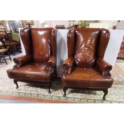 15 - Matching Pair of large Brown Leather High-back Armchairs, with similarly covered cushion seats, on Q... 