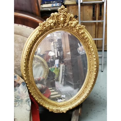 195 - Oval, portrait-shaped ornate gold framed Wall Mirror, heavily detailed with a central plaque above r... 