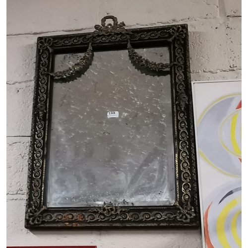 198 - French Wall Mirror, bevelled glass, the ebony finished frame mounted with decorative metal designs a... 