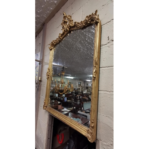 200 - Carved gilt wood Overmantle Wall Mirror with a scrolled and floral encrusted pediment and décor to l... 