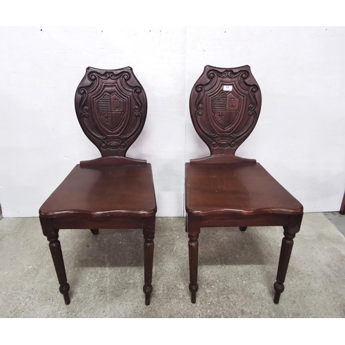 32 - Matching Pair of vintage era carved walnut Hall Chairs, heraldic décor (some damage and repairs) (2)