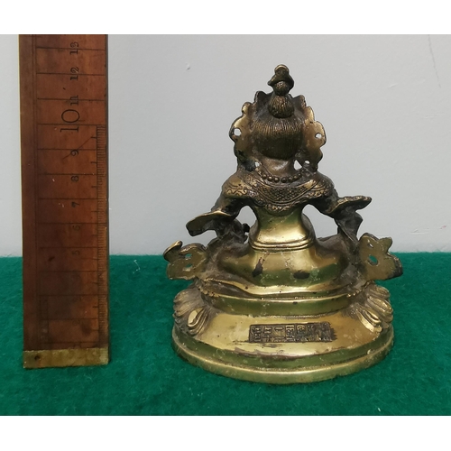 328 - Small brass figure of a seated Tibetan God, inset with colour stones, signed at the back, 15cm H x 1... 