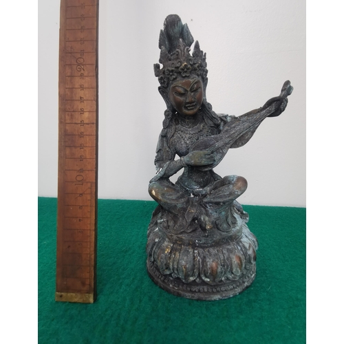 330 - Antique bronze figure of a seated Tibetan figure, playing a string instrument, 24cmH x 14cmW