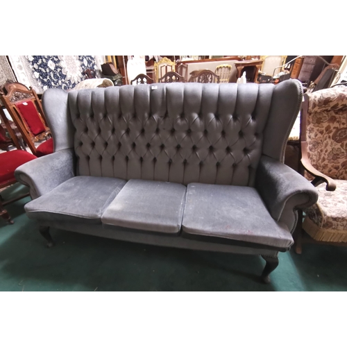 34 - Long blue velvet covered Settee, 3-seater, button detail to the high back (wing ends), on padded fro... 