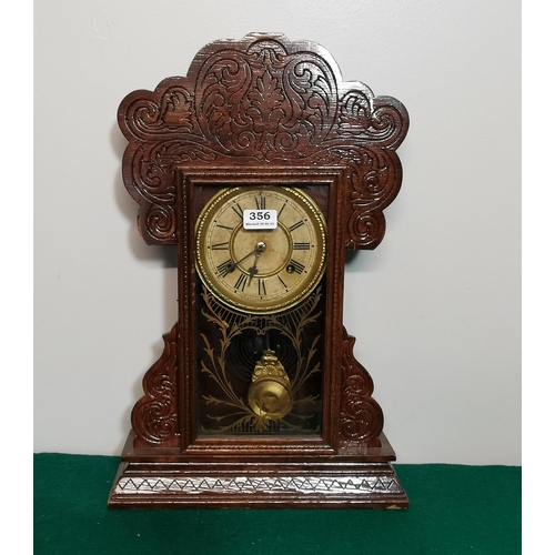 356 - Waterbury Mantle Clock, in a carved walnut (varnished) case