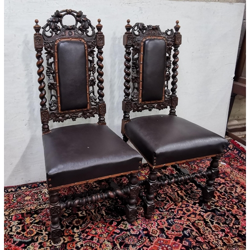 43 - Pair of heavily carved Oak Hall Chairs, black leatherette covered seats, leaf carvings (1 top damage... 