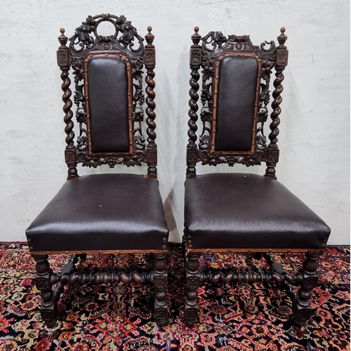 43 - Pair of heavily carved Oak Hall Chairs, black leatherette covered seats, leaf carvings (1 top damage... 