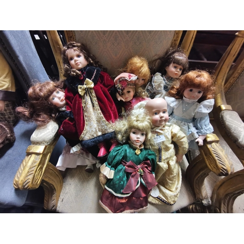 465 - 9 (small sized) Porcelain Dolls, various colourful dresses