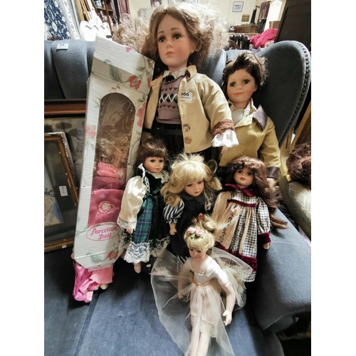 466 - 8 Porcelain Dolls, various colourful dresses (includes a tall similar boy and girl pair)