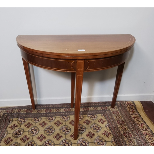 69 - Demi-Lune Inlaid Mahogany Fold-over Card Table with green baize covered interior, on tapered legs, 9... 