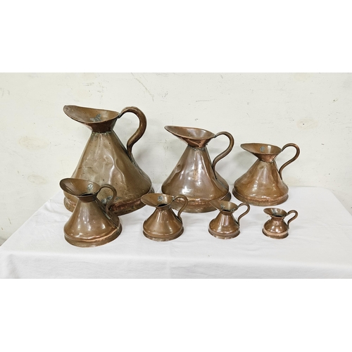 310 - Matching Set of 7 Antique Copper Measuring Jugs, all graduating (some wear/dents), from 1 Gallon to ... 