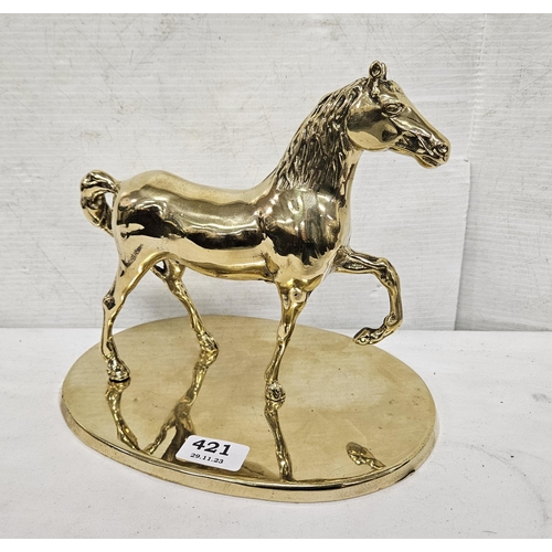 421 - Brass Model of a Stallion, on an oval base (polished), 27cmW x 23cmH