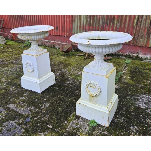 445 - Matching Pair of white painted cast iron Garden Urns - campana form - each upon a square pedestal ba... 