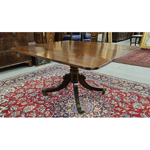 79 - Regency Mahogany Dining Table on a tripod splayed leg base with cast brass toes and castors (varnish... 