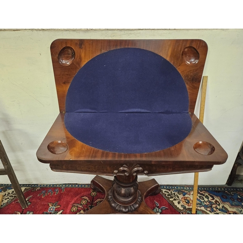 86 - WMIV Mahogany Card Table, fold-over design with a blue baize interior and game/token wells, on a mou... 