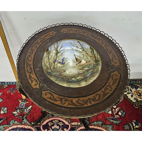 92 - Ebonised Occasional Table, circular, with a brass gallery and porcelain plate insert, decorated with... 