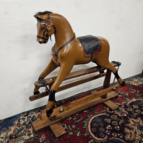 448 - Mid-20thC Rocking Horse, painted brown, with glass eyes, supported on a pitch pine frame (good condi... 