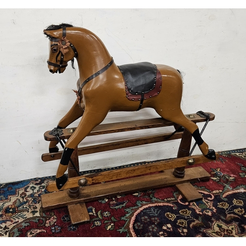 448 - Mid-20thC Rocking Horse, painted brown, with glass eyes, supported on a pitch pine frame (good condi... 